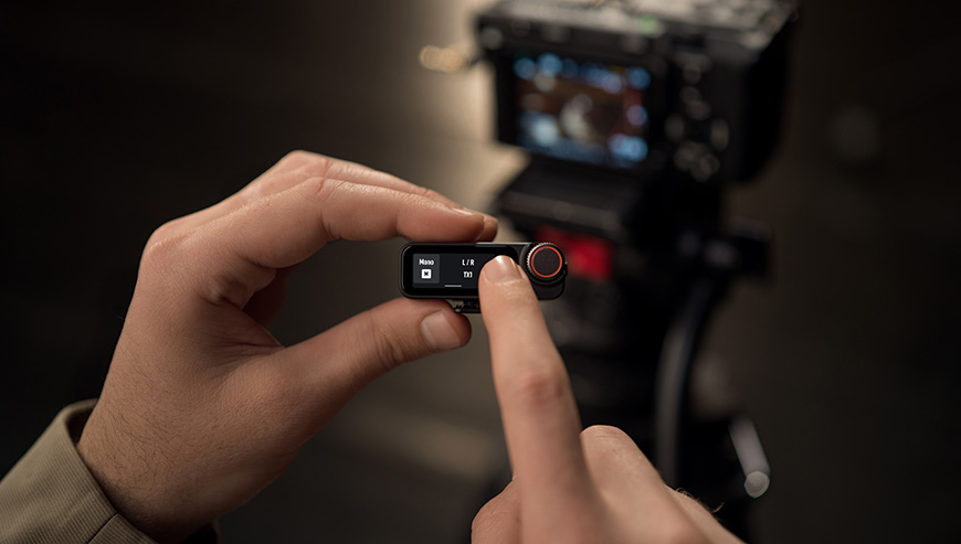 System mikrofonów bezprzewodowych DJI Mic 3 2 TX + 2 RX + Etui ładujące czarny grafika przedstawia mężczyznę ustawiającego parametry mikrofonu 